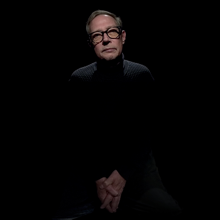 Christoph Eichhorn against black background. Studio portrait for 360º Bulletin Berlin by Gavin Evans